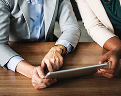 close shot of two people looking at tablet computer