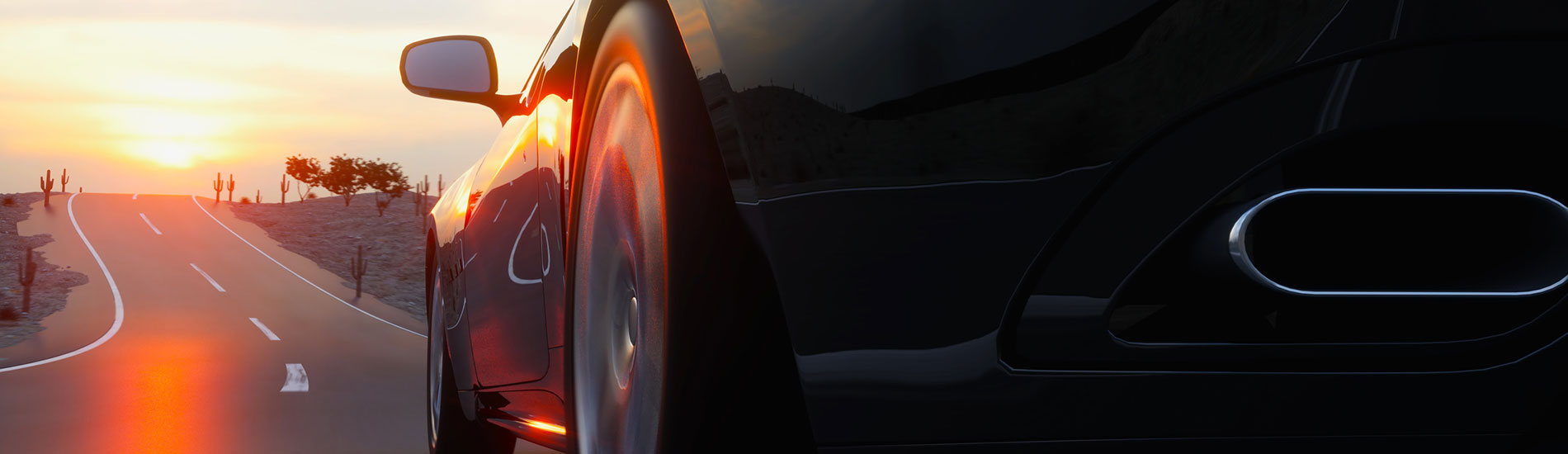 car driving on road into sunset