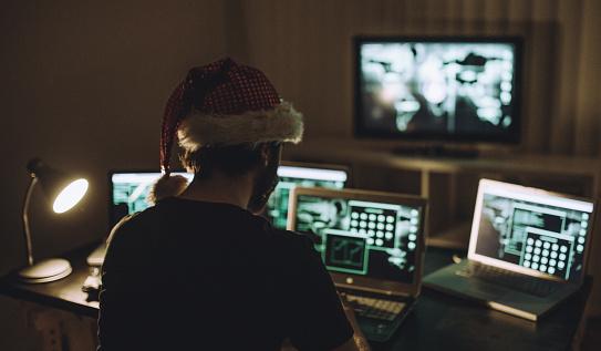 Hacker sitting in front of computer Screen