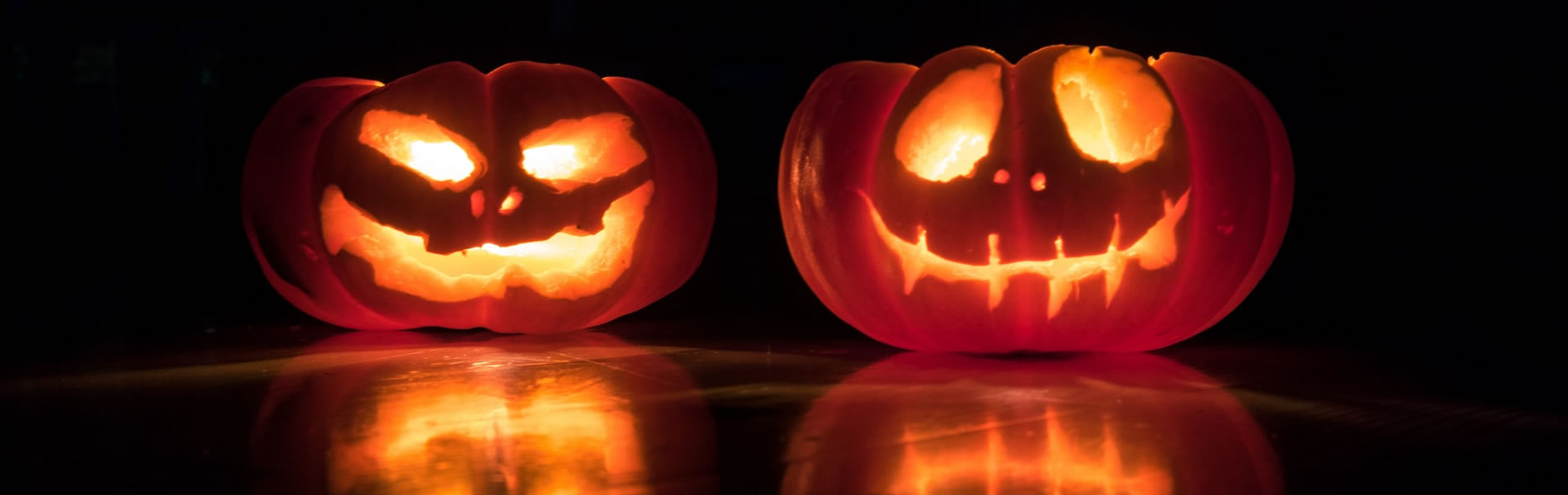 Two jack-o-lanterns illuminated from the inside